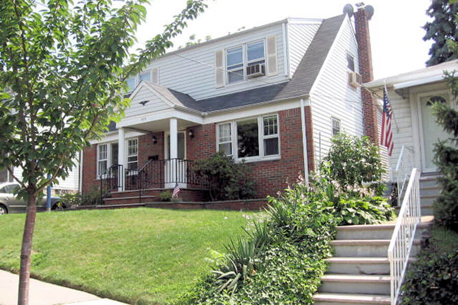 An image of a residential property in need of soil remediation used to depict Tank Solutions's oil-contaminated property buying program.